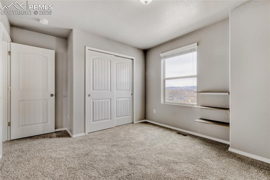 Image 19 of 34: Carpeted bedroom with  closet, shelving, and Mountain View