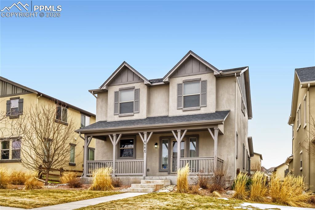 Image 2 of 34: View of front of property with stucco and covered porch