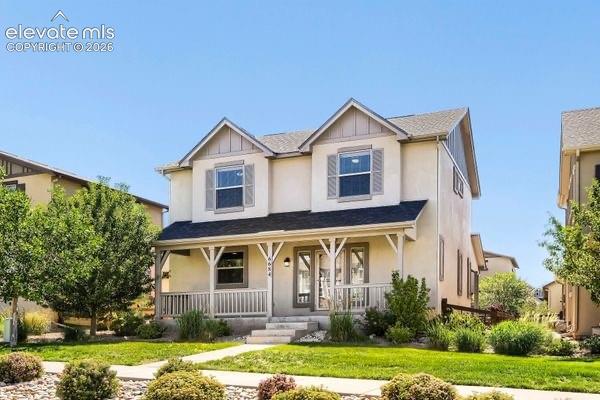 Image 2 of 35: Two-story residence featuring a covered front porch, gabled rooflines, and
