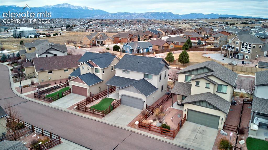 Image 28 of 35: Aerial view of residential area with mountains backdrop