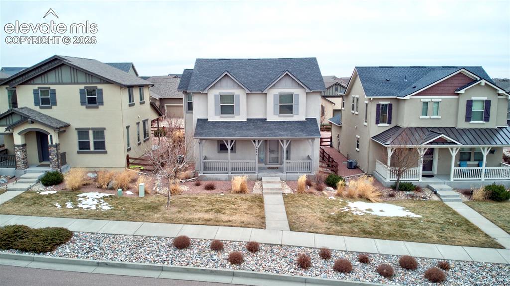 Image 30 of 35: View of front of property with stucco, residential view, covered porch, and
