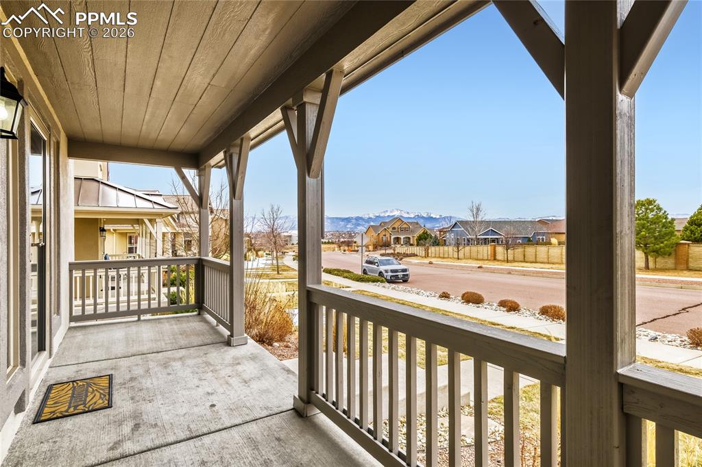 Image 4 of 34: Covered porch featuring a residential view and a mountain view