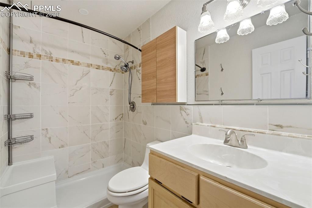 Image 13 of 24: Really well done bathroom with the ability to sit down in the shower. 