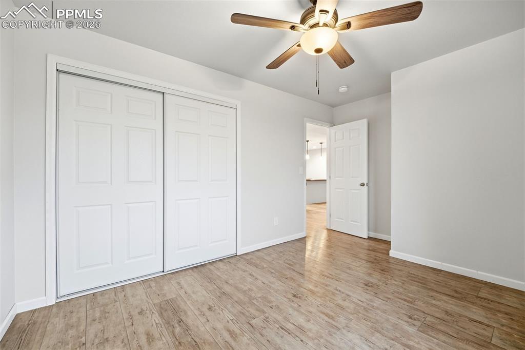 Image 15 of 24: Primary bedroom with nice sized closet and a remoted controlled ceiling fan