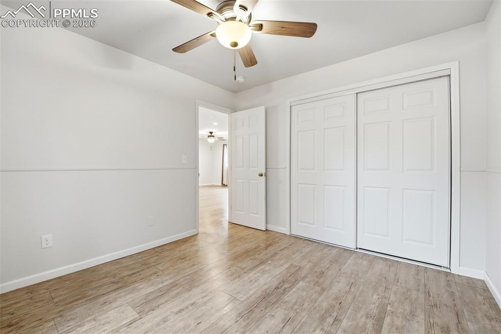 Image 17 of 24: 2nd spatious bedroom with closet and remote controlled ceiling fan.