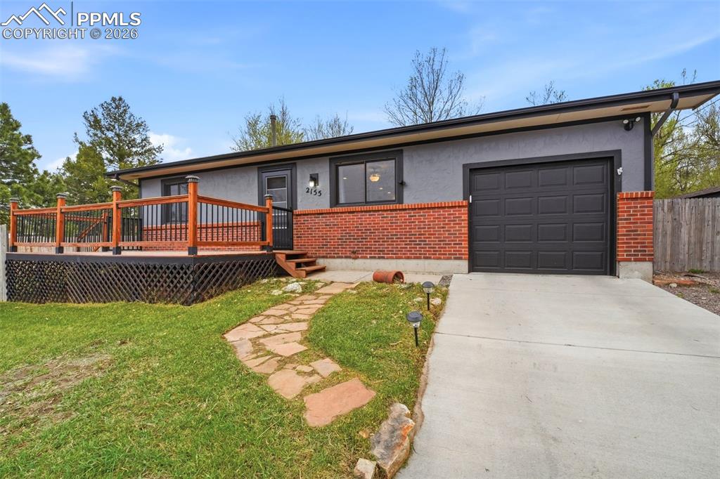 Image 3 of 24: Attached garage and big front deck for summertime grilling!