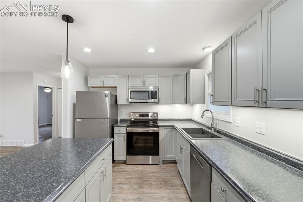Image 9 of 24: Kitchen island and under cabinet lighting.