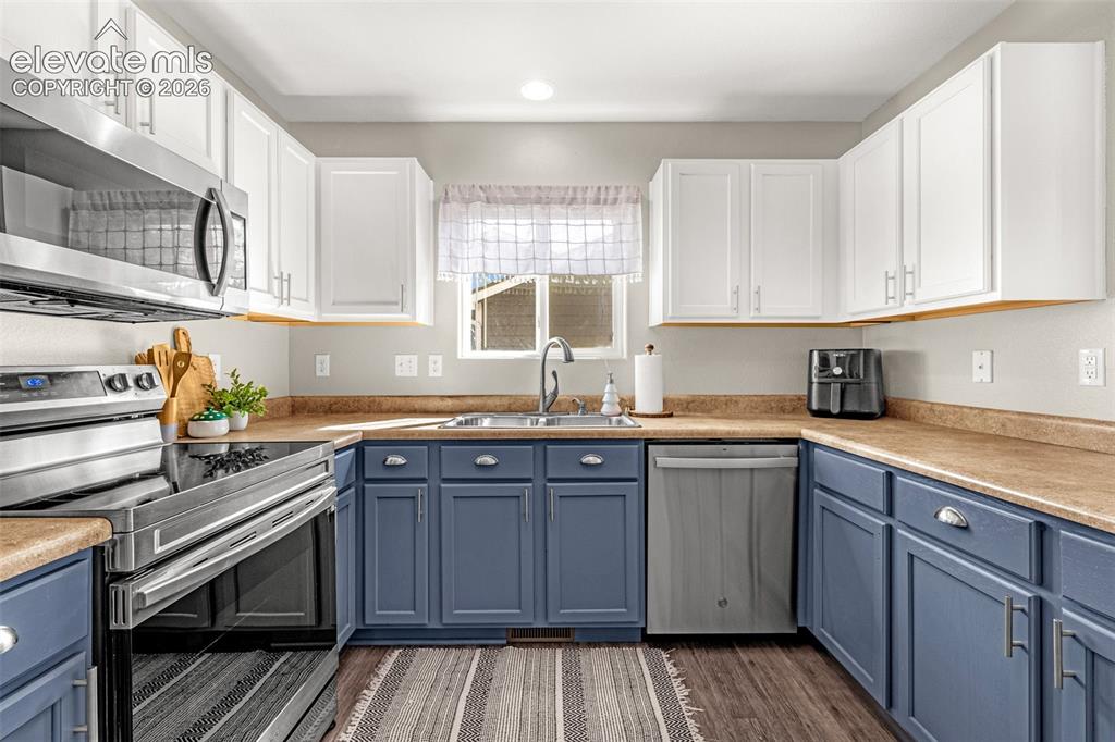 Image 10 of 37: Kitchen featuring two-tone cabinetry, stainless steel appliances, laminate 