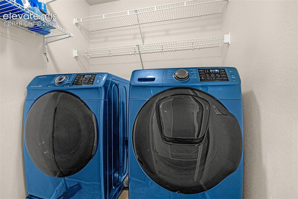 Image 13 of 37: Laundry area with white wire shelving