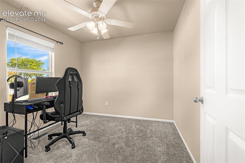 Image 16 of 37: Recessed window with white blinds, neutral wall paint, ceiling fan with int