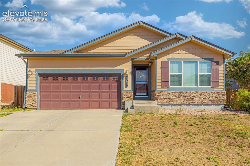 Image 2 of 37: Exterior featuring horizontal siding, stone veneer accents, an attached gar