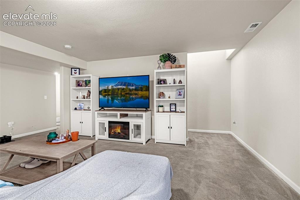 Image 22 of 37: Spacious room featuring carpeting, recessed lighting, and a built-in media
