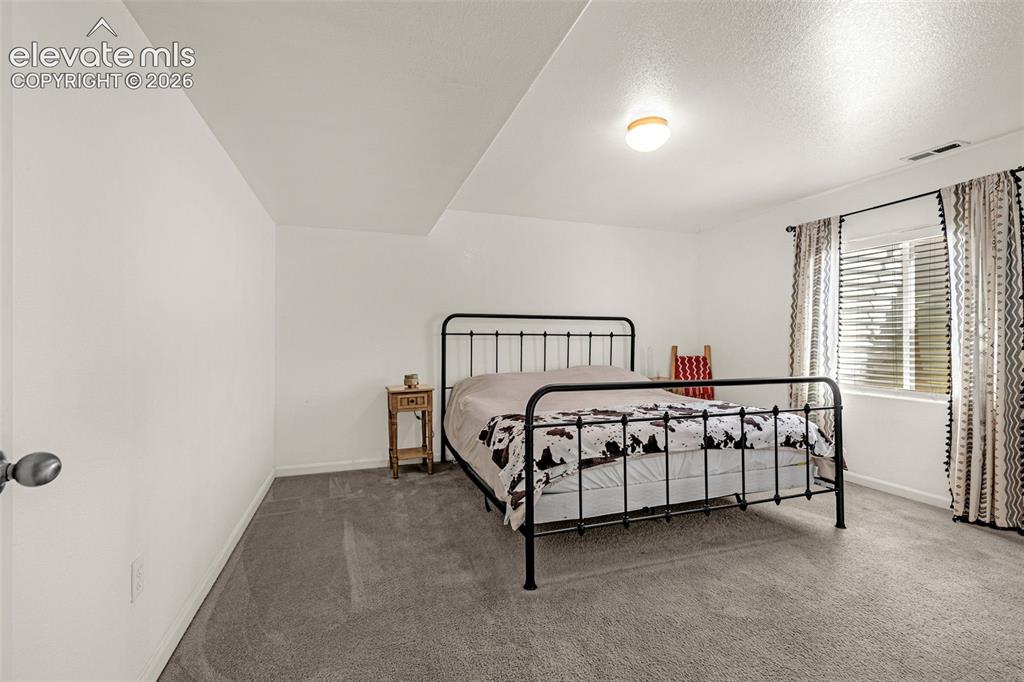 Image 25 of 37: Recessed ceiling, neutral wall paint, carpet flooring, window with blinds,