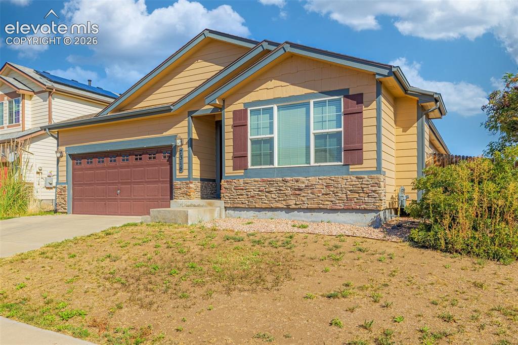 Image 3 of 37: Siding exterior with stone accents, attached garage, concrete driveway, and