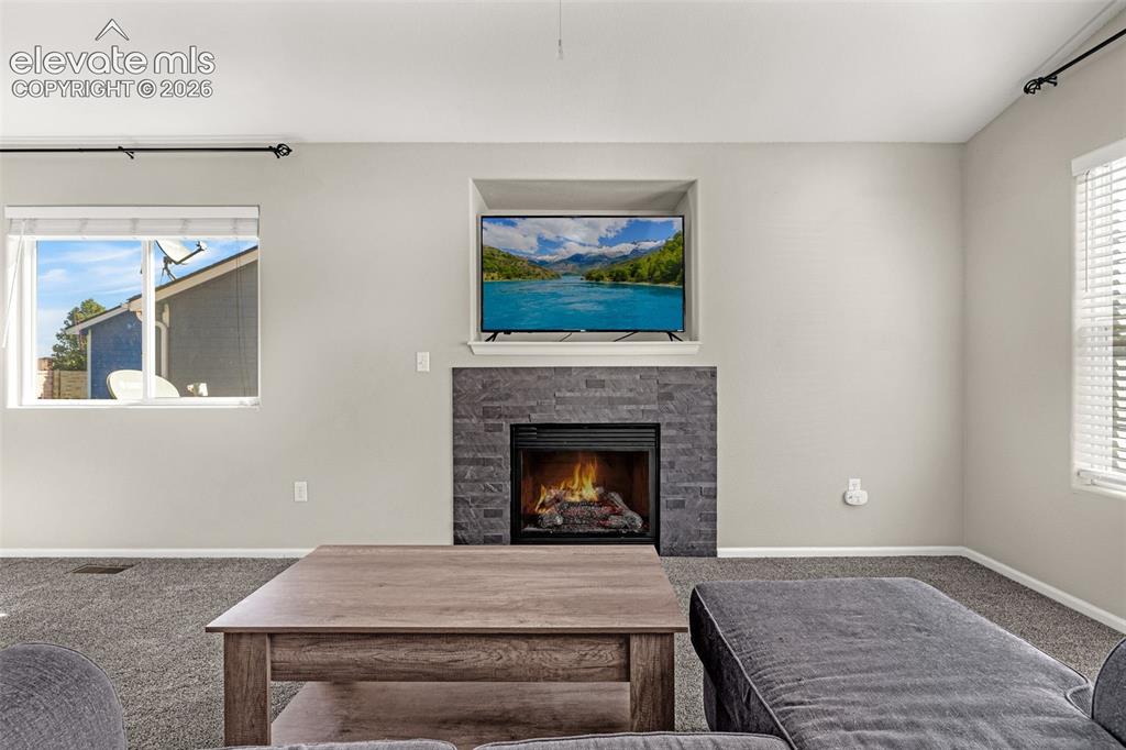 Image 7 of 37: Built-in media niche above a stone-clad fireplace