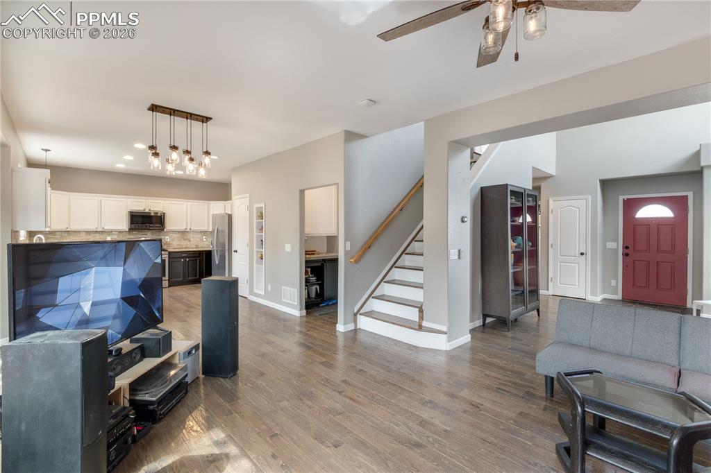 Image 10 of 39: Living room featuring light wood-type flooring, a ceiling fan, and recessed