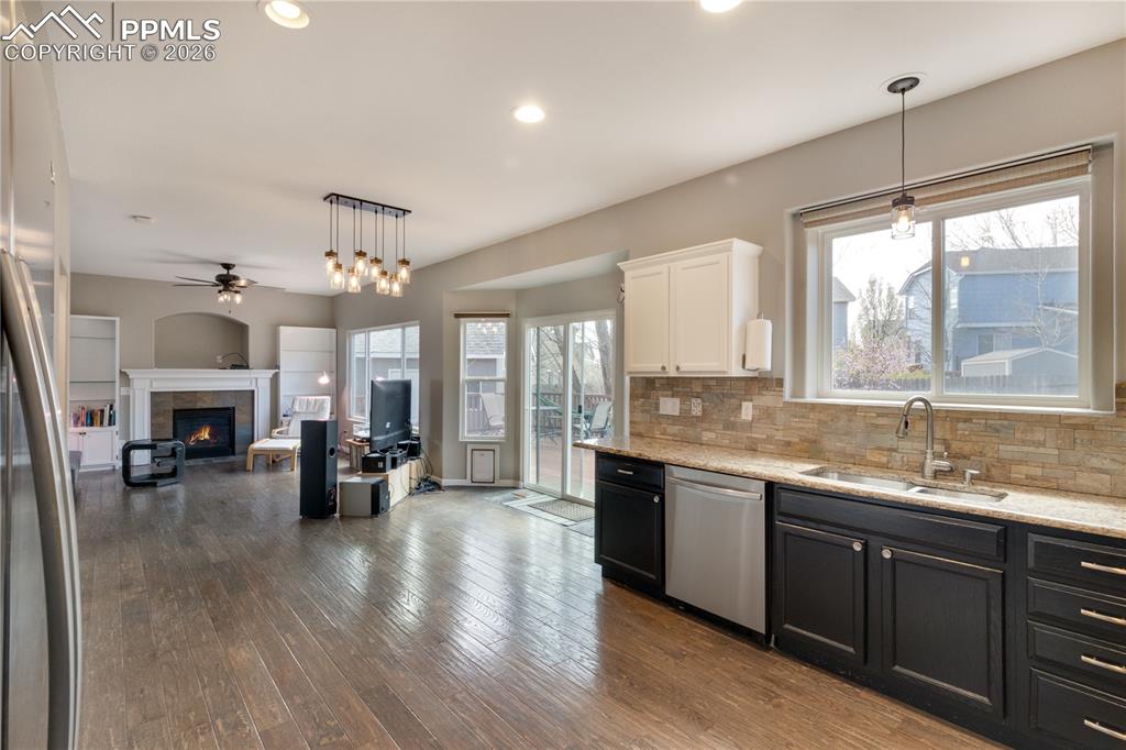 Image 12 of 39: Kitchen with , stainless steel appliances, two tone cabinets, a ceiling fan