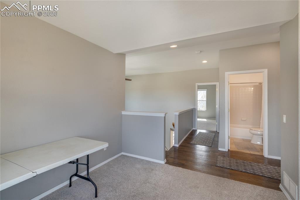 Image 15 of 39: Unfurnished office with dark carpet and recessed lighting