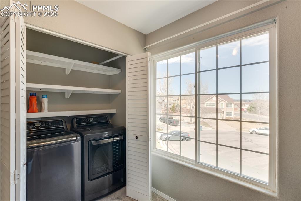 Image 17 of 39: Laundry area featuring separate washer and dryer and baseboards