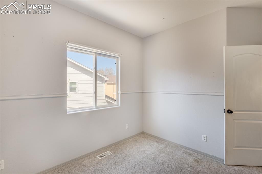 Image 21 of 39: Spare room featuring carpet floors and baseboards