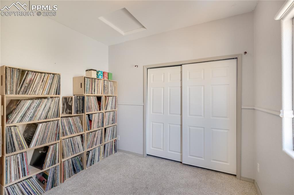 Image 22 of 39: Bedroom featuring light colored carpet and a closet