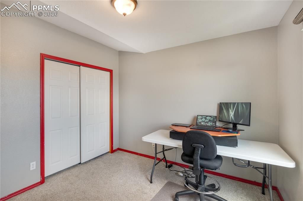 Image 25 of 39: Office area with light colored carpet and baseboards