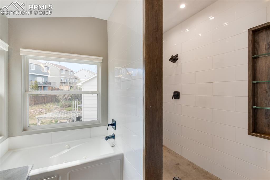 Image 30 of 39: Full bathroom featuring a bath and walk in shower