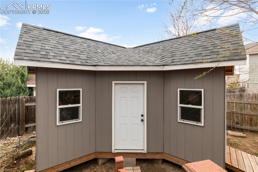 Image 36 of 39: View of shed featuring a fenced backyard
