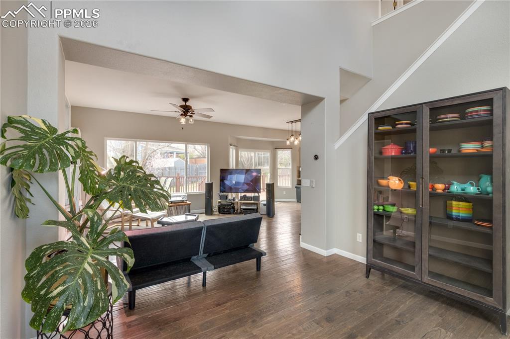 Image 7 of 39: Living room with dark wood-style flooring and ceiling fan