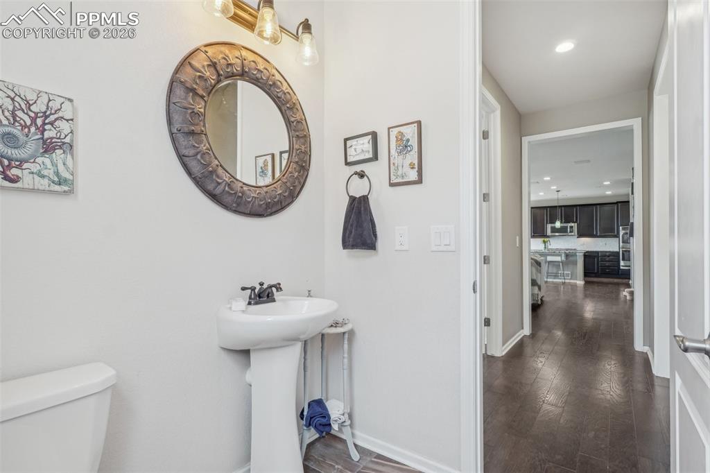 Image 20 of 50: Half bath by laundry and garage drop area