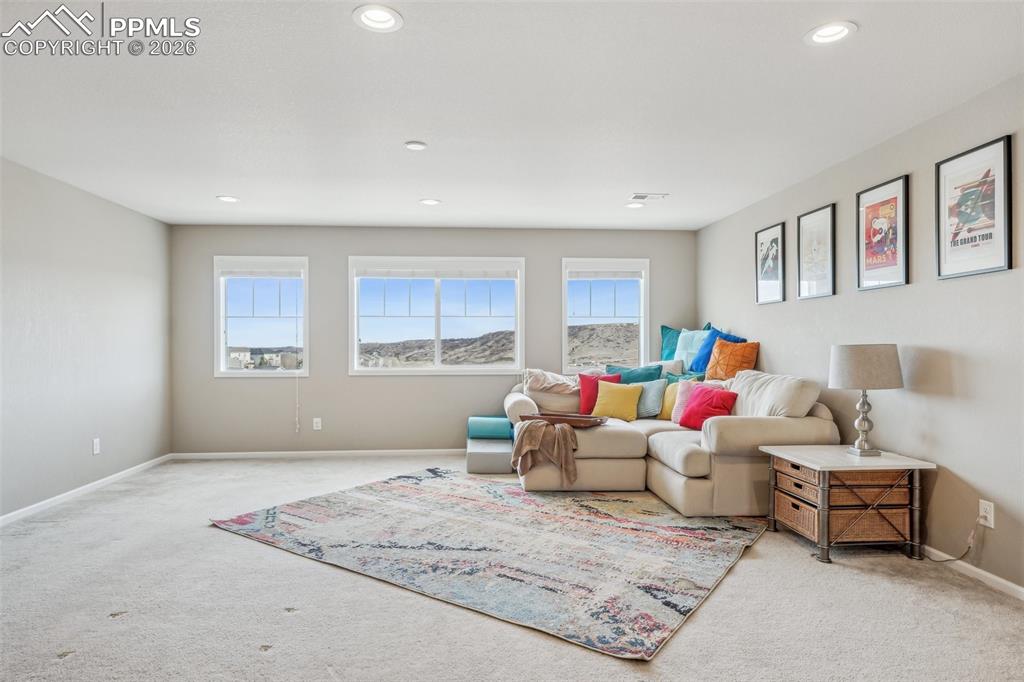 Image 23 of 50: Huge loft media space with carpet and more views