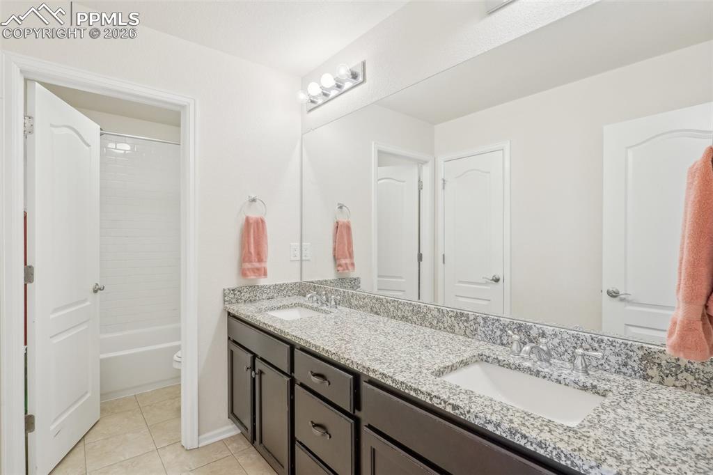 Image 33 of 50: Full bath for bedrooms 3 and 4, double sinks, granite countertops, tile flo