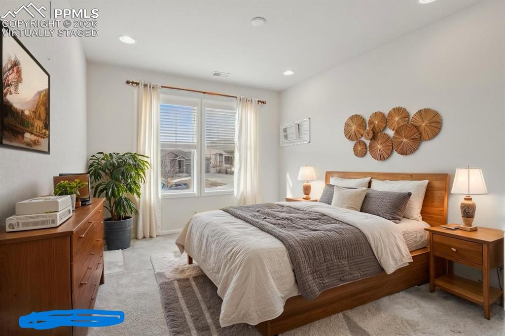 Image 36 of 50: Virtually staged Bedroom 4 with light carpet and recessed lighting