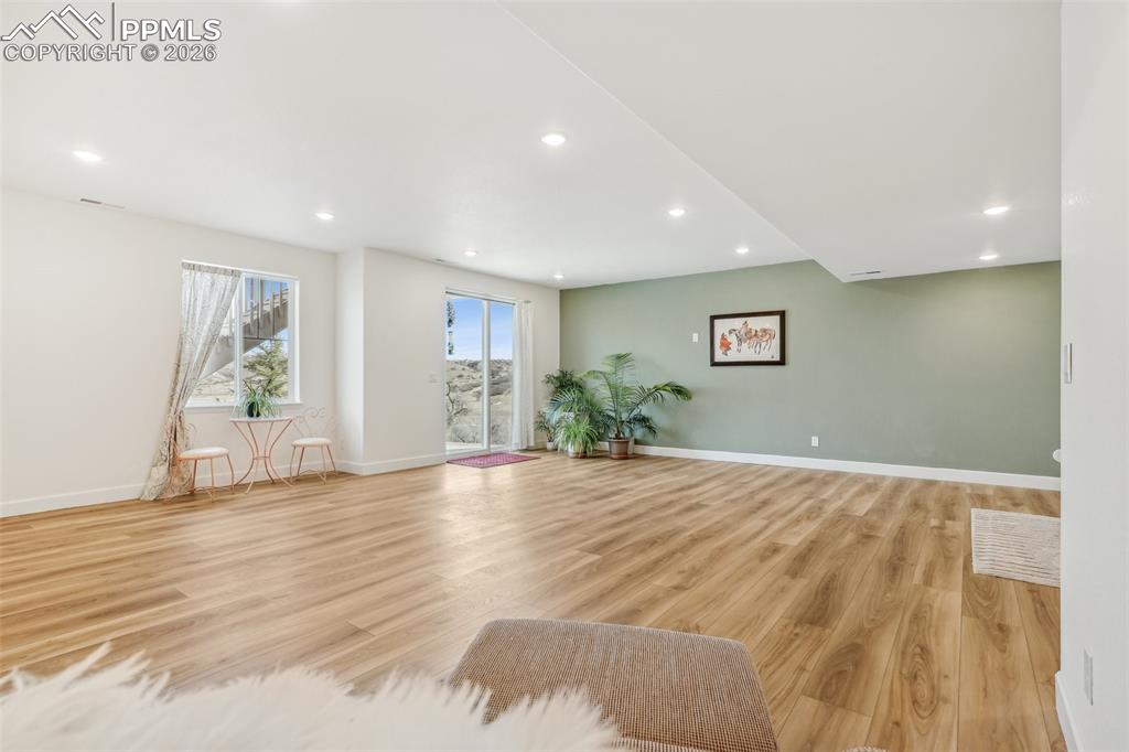 Image 38 of 50: LVP flooring, Great room in basement with walk out professionally finished 