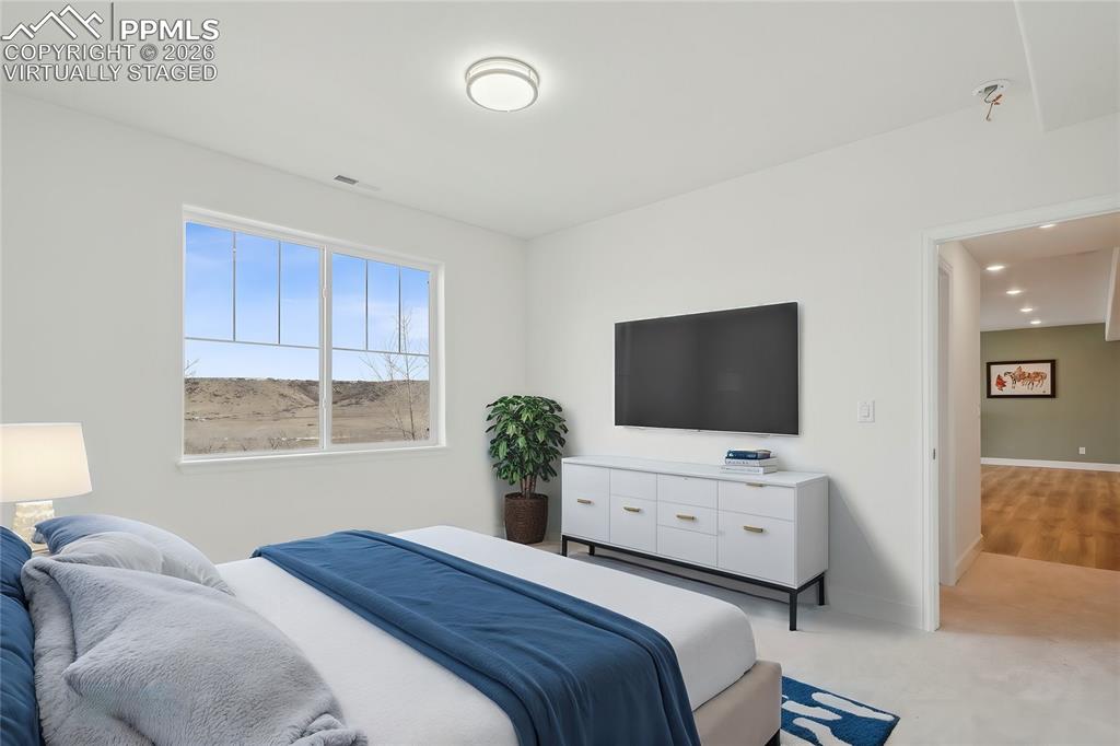Image 42 of 50: 
Virtually Staged Bedroom 5 in basement, conforming with views, walk in clo