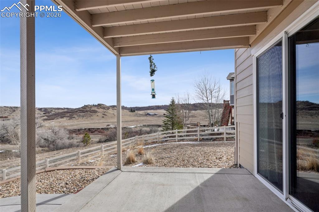 Image 46 of 50: View of patio from walk out, concrete path along side of house to access fr