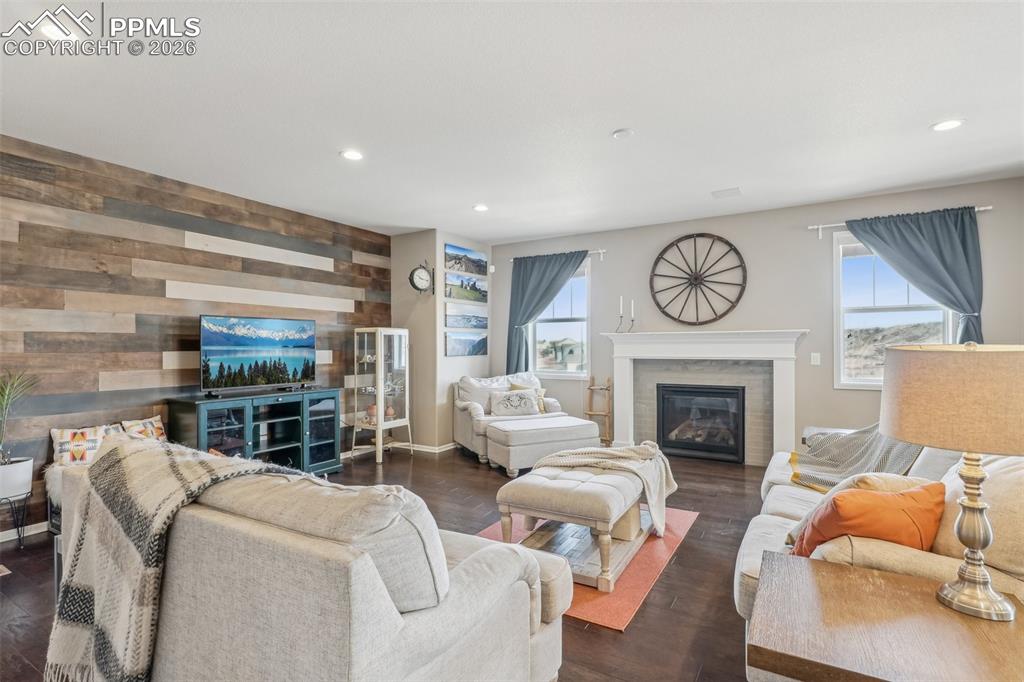 Image 6 of 50: Living room featuring a glass covered fireplace, healthy amount of natural 