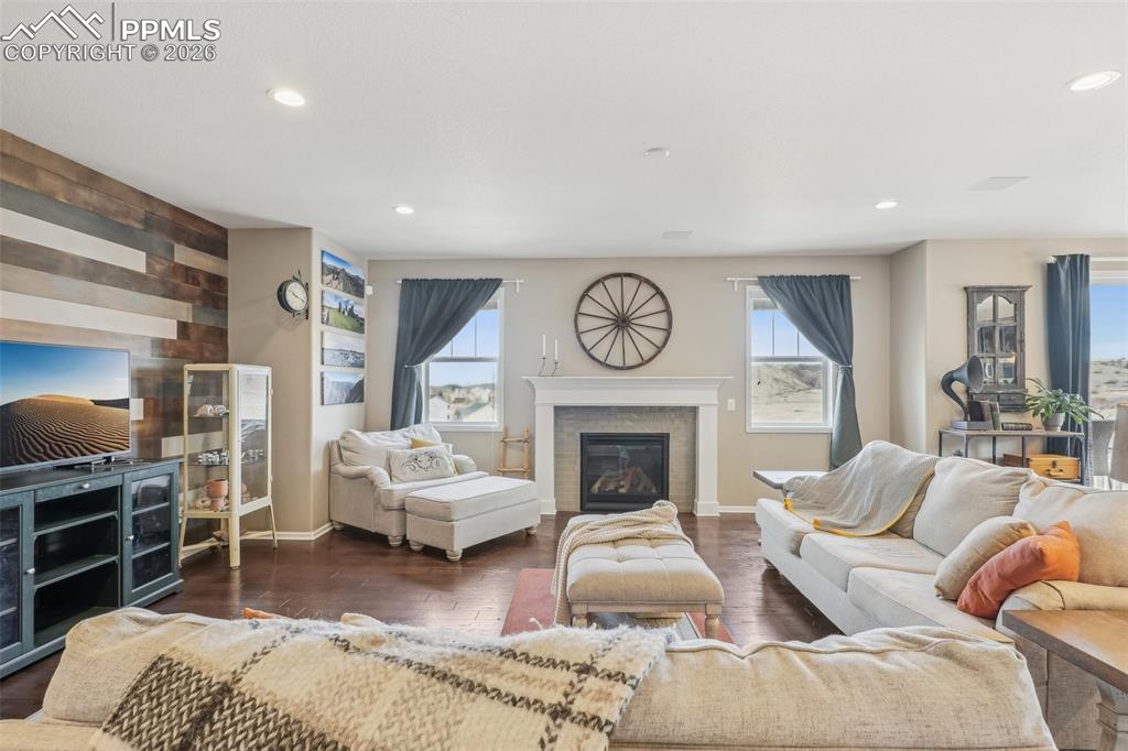 Image 7 of 50: Living area with recessed lighting, baseboards, a glass covered fireplace, 