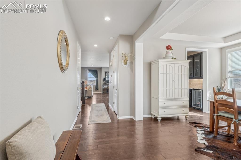 Image 8 of 50: Hall with dark wood floors, recessed lighting, 9 foot ceilings
