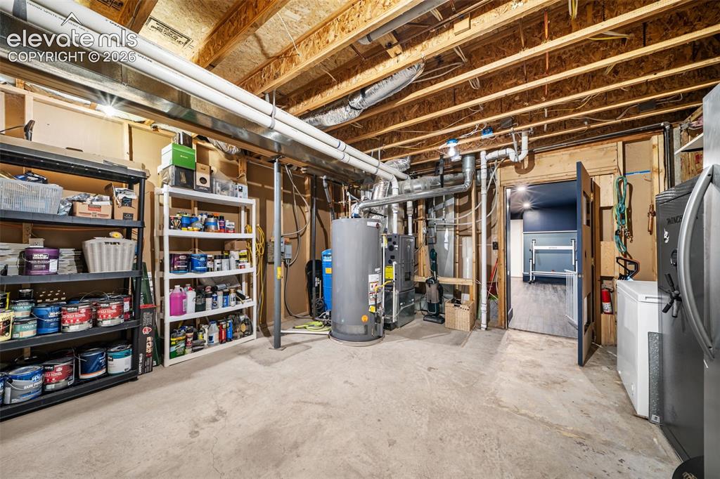 Image 34 of 50: Utility Room is large with room for second fridge and several deep freezers