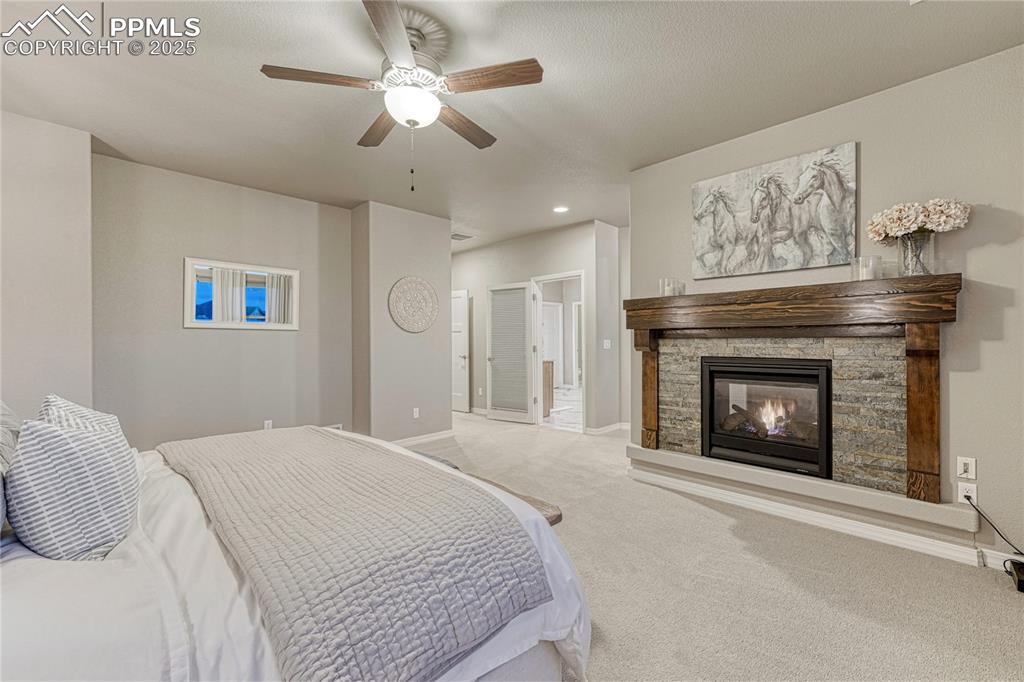 Image 18 of 48: Cozy, double-sided fireplace in the primary suite