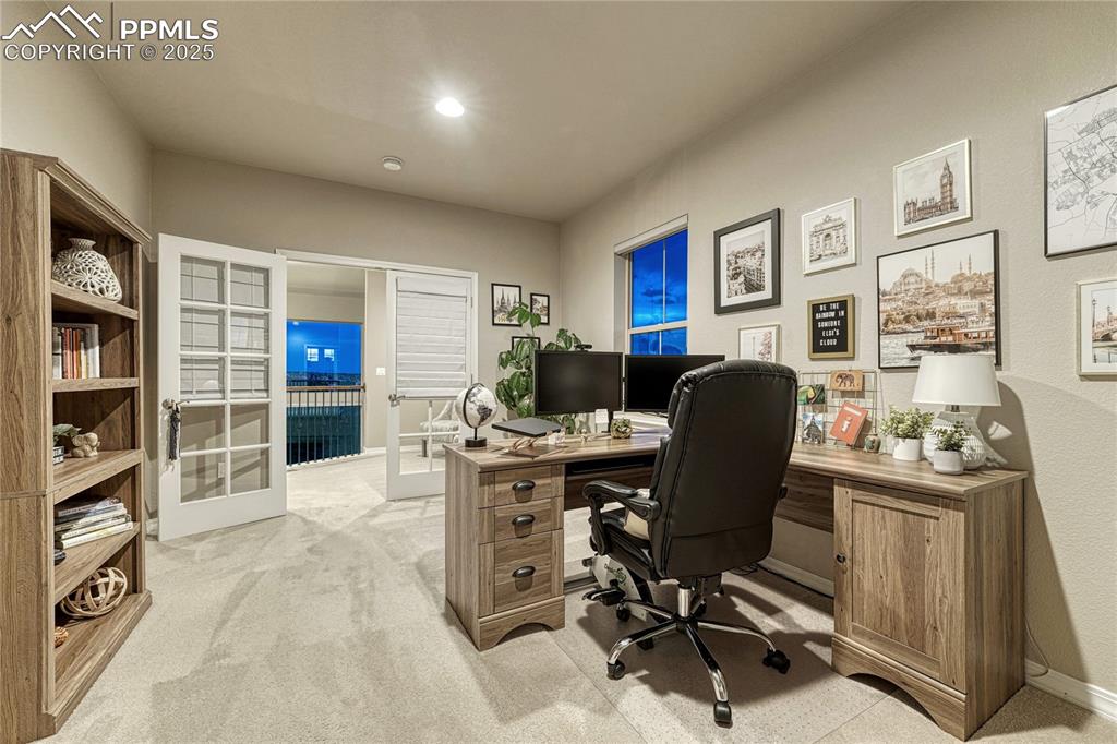Image 27 of 48: Spacious home office with French doors and lots of light! 