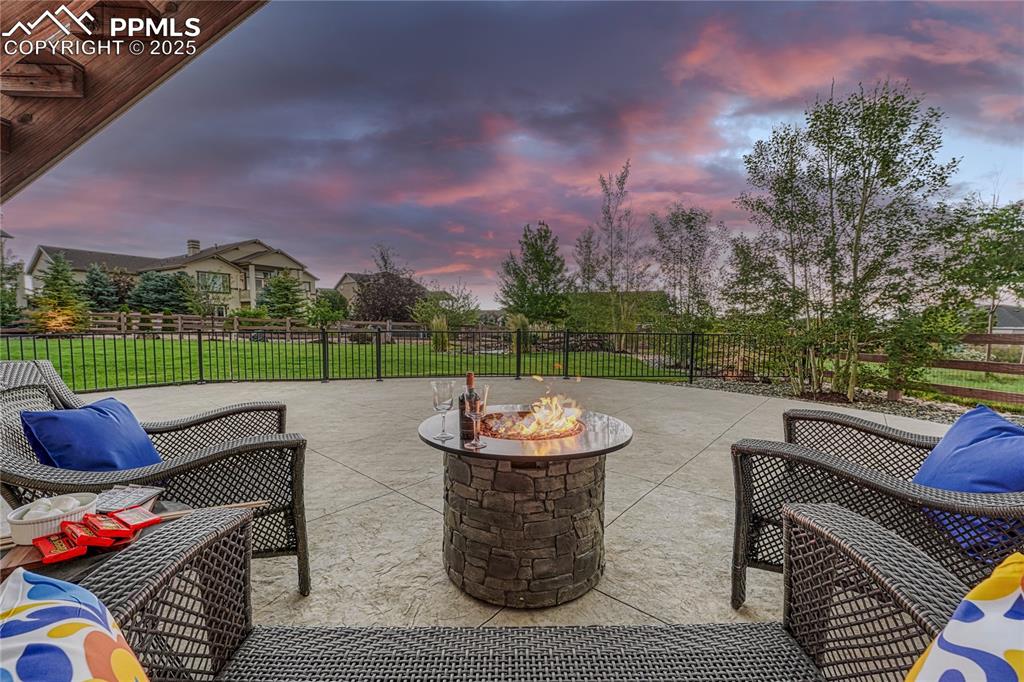 Image 39 of 48: Patio terrace at dusk, featuring stamped concrete - perfect for cozy, quiet