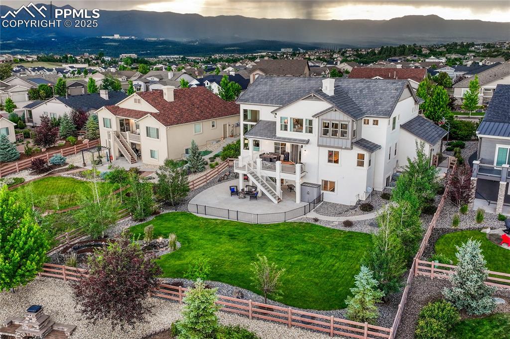 Image 45 of 48: Aerial perspective of suburban area with a mountainous background