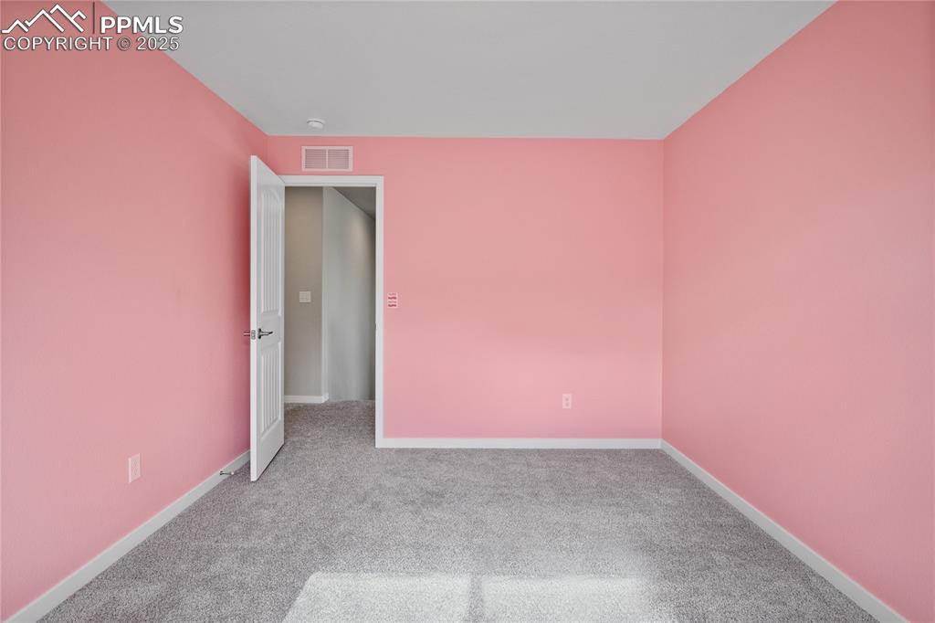 Image 22 of 50: Empty room with carpet flooring and baseboards