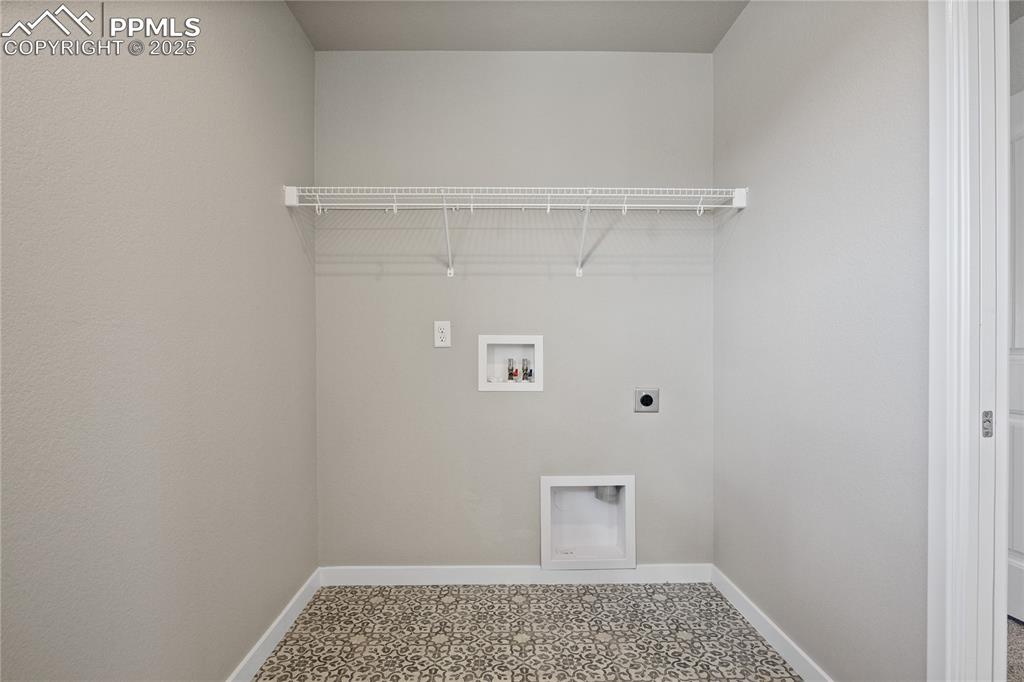 Image 26 of 50: Washroom with electric dryer hookup, hookup for a washing machine, and base