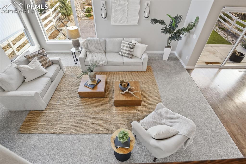 Image 36 of 50: Living area featuring baseboards and carpet floors