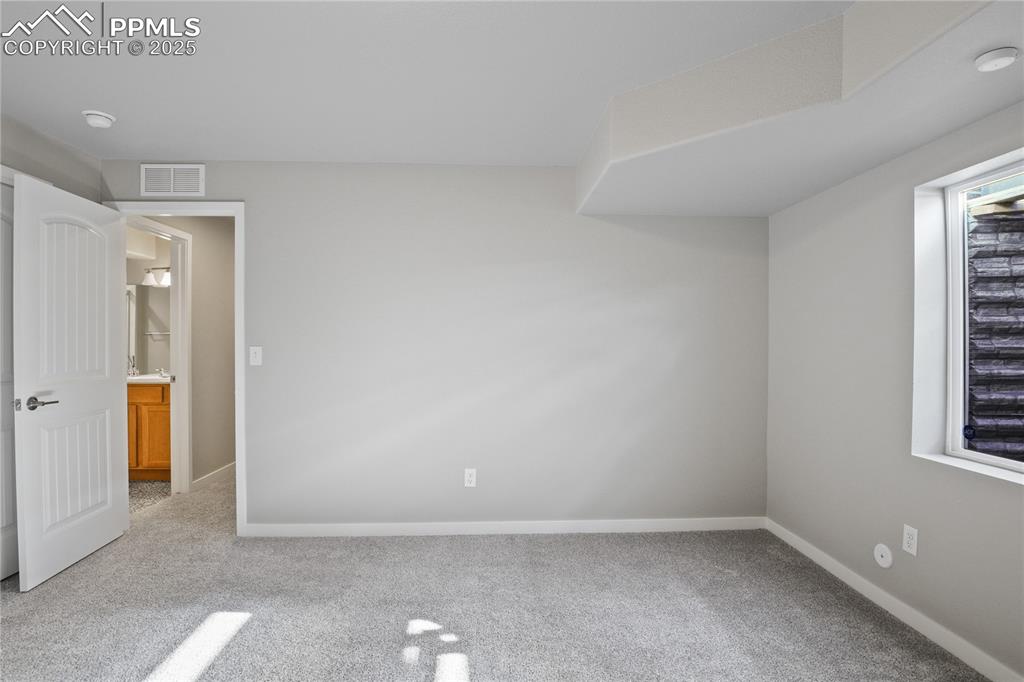 Image 42 of 50: Unfurnished bedroom with carpet flooring and baseboards