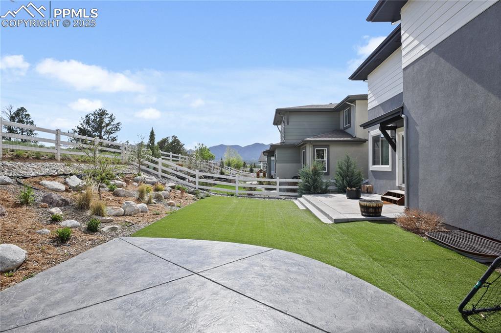 Image 43 of 50: View of yard with a patio area and a mountain view