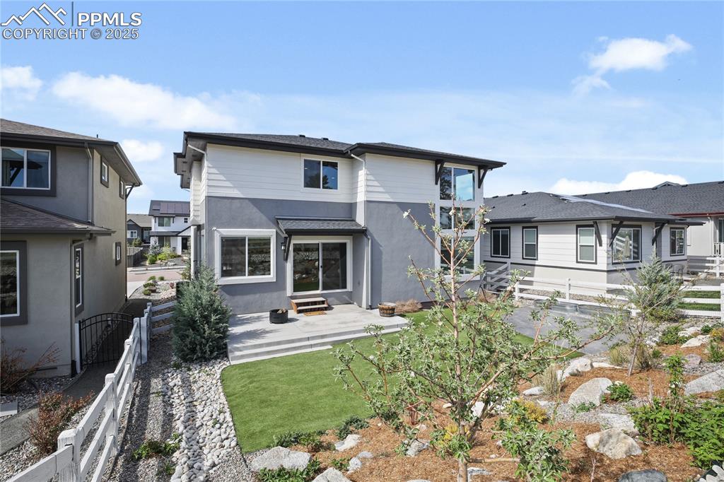 Image 46 of 50: Back of property featuring stucco siding and a patio